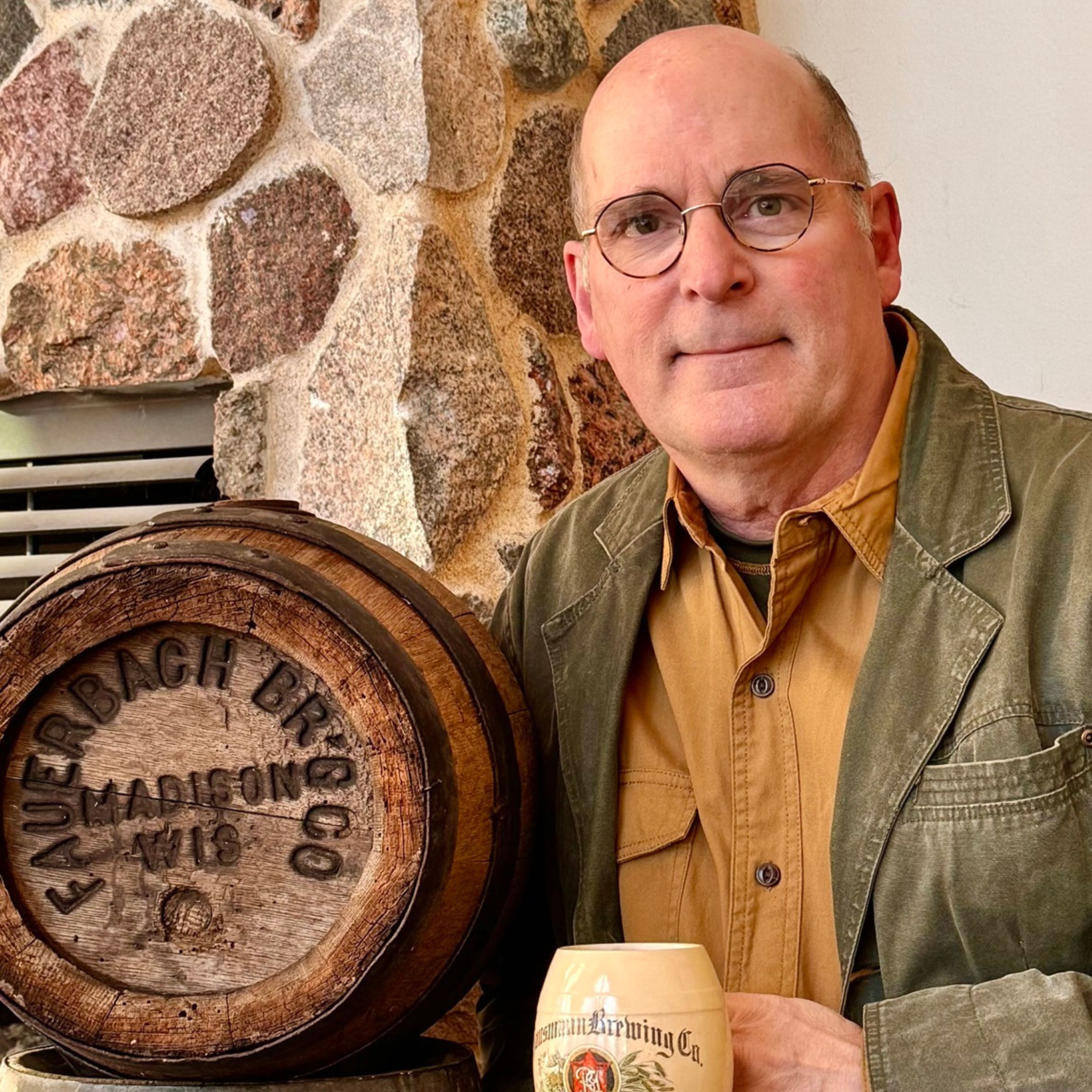 A photograph of author Robin Shepard standing next to a beer keg.